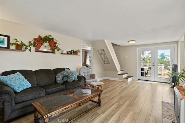 living room featuring light hardwood / wood-style flooring and french doors