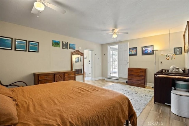 bedroom with ceiling fan and light hardwood / wood-style flooring