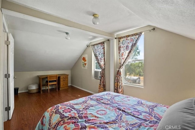 bedroom featuring a textured ceiling, dark hardwood / wood-style flooring, and vaulted ceiling