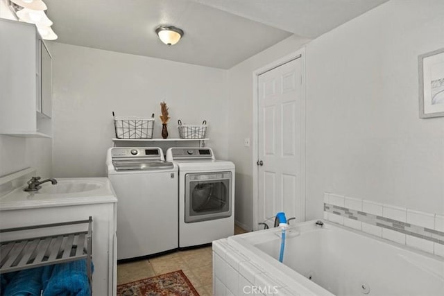 clothes washing area featuring light tile patterned floors, sink, and washing machine and clothes dryer