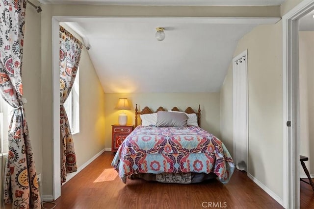 bedroom featuring wood-type flooring and vaulted ceiling