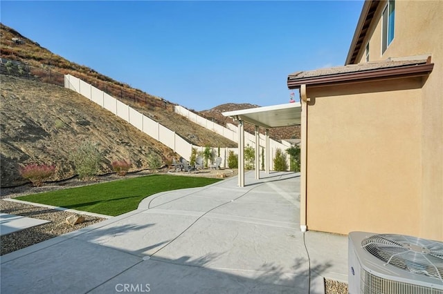 view of patio with a mountain view and central AC