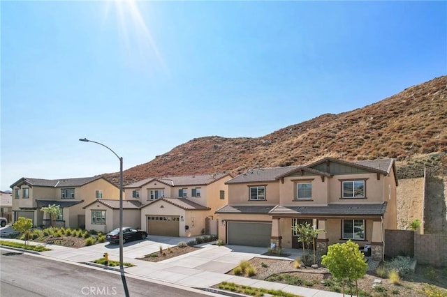 view of front of property featuring a mountain view and a garage