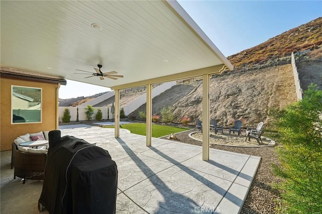 view of patio / terrace featuring a mountain view, outdoor lounge area, area for grilling, and ceiling fan