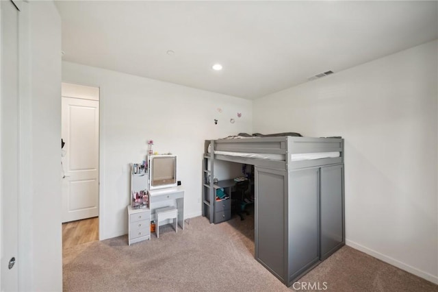 bedroom featuring light colored carpet