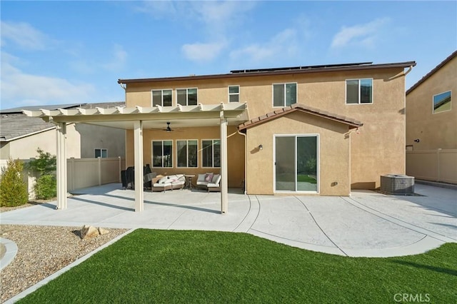 back of house featuring an outdoor hangout area, ceiling fan, central AC, a patio area, and a yard