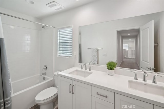 full bathroom with vanity, toilet, and shower / tub combo with curtain