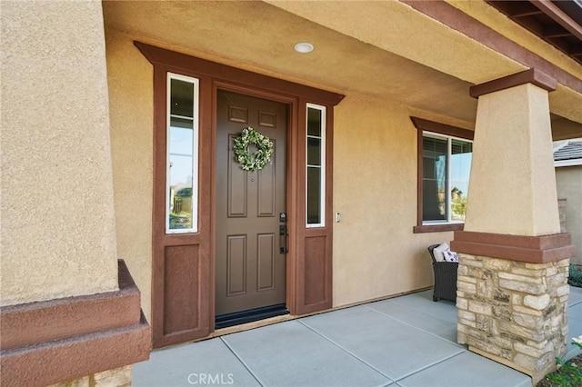 doorway to property featuring a porch