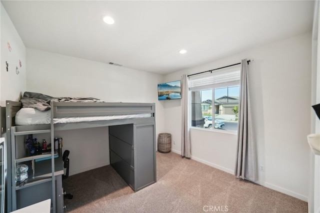 bedroom with light colored carpet