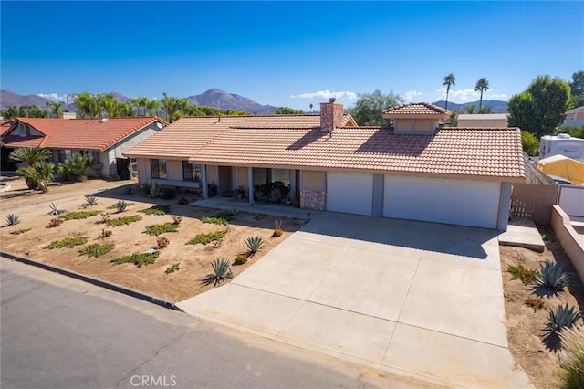 34578 Hickory Ln, Wildomar, CA 92595 - ranch-style home with a tile roof, a mountain view, an attached garage, and a chimney