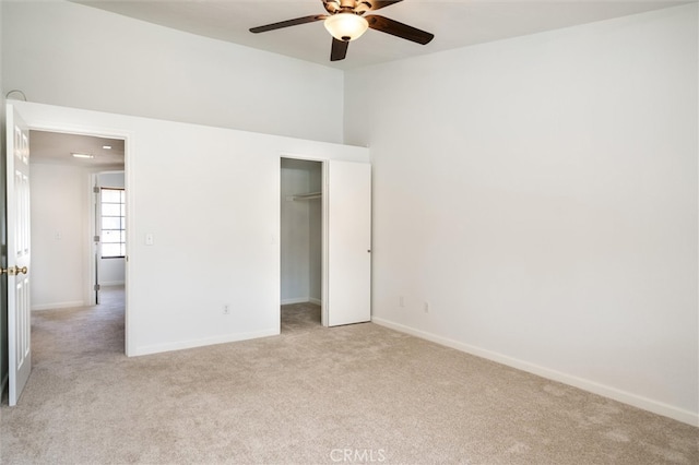 unfurnished bedroom featuring light carpet, a closet, and ceiling fan