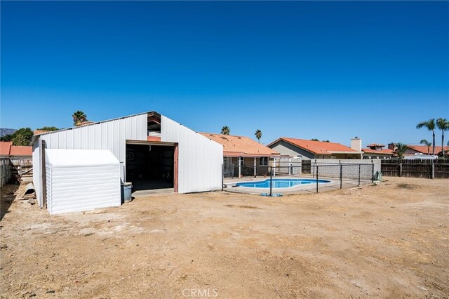 view of swimming pool featuring an outdoor structure