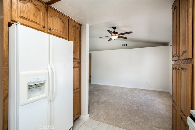 kitchen with white fridge with ice dispenser, light colored carpet, vaulted ceiling, and ceiling fan