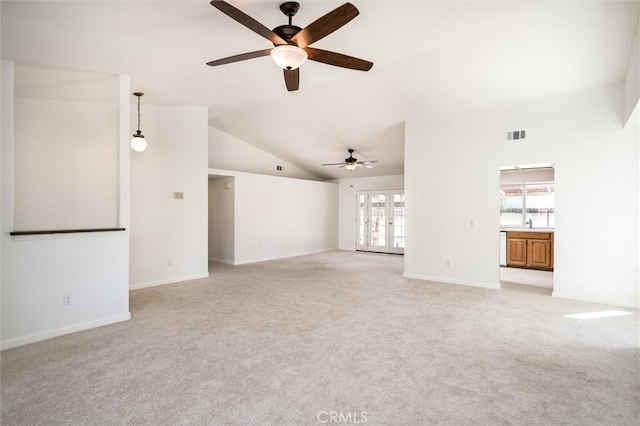 unfurnished living room with french doors, light colored carpet, and a healthy amount of sunlight