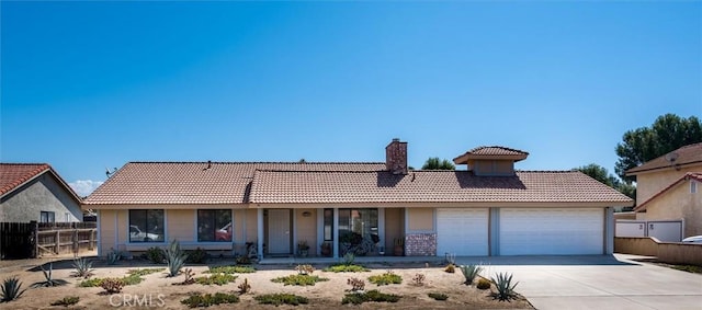 34578 Hickory Ln, Wildomar, CA 92595 - view of front facade with a tiled roof, a garage, a chimney, and covered porch