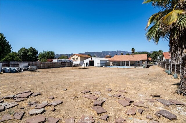 view of yard featuring a mountain view and a fenced in pool