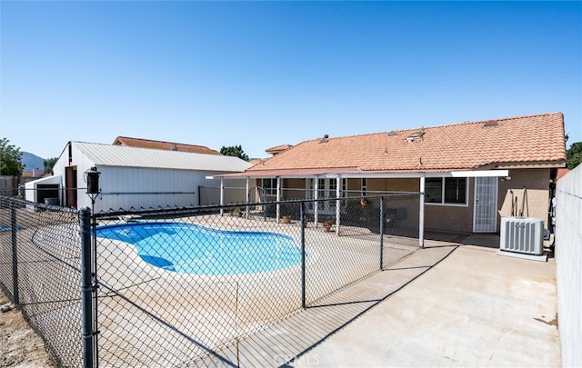 view of pool featuring a patio and central AC