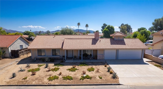 ranch-style home featuring a mountain view and a garage