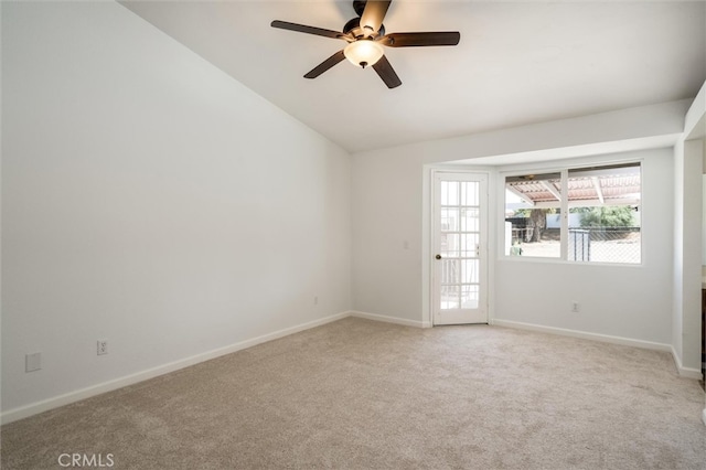 carpeted empty room with vaulted ceiling and ceiling fan