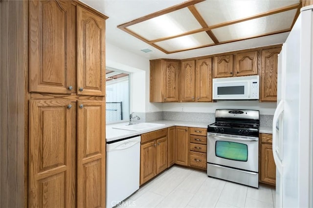34578 Hickory Ln, Wildomar, CA 92595 - kitchen featuring white appliances, a sink, brown cabinets, and light countertops