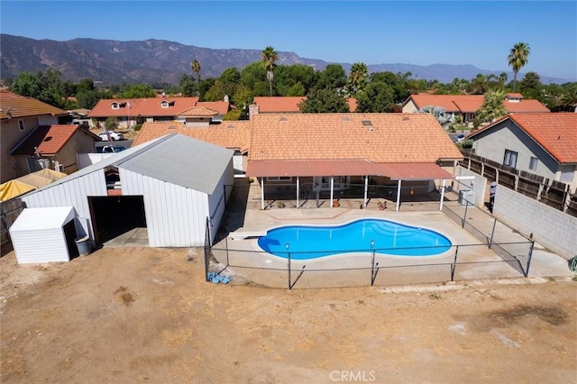 34578 Hickory Ln, Wildomar, CA 92595 - view of pool featuring a mountain view, a residential view, a diving board, and an outdoor structure