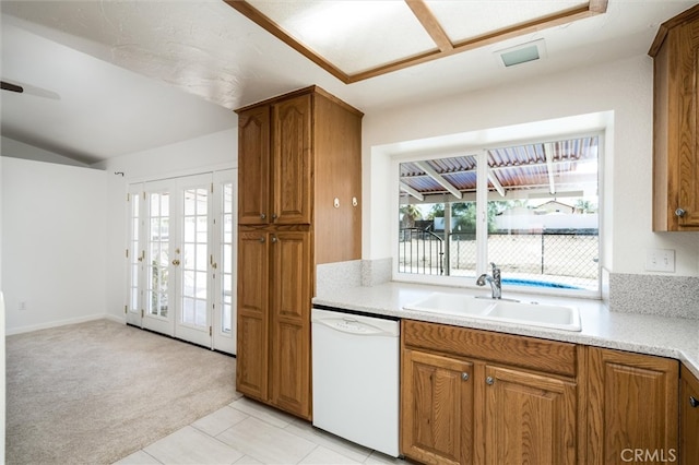 kitchen featuring french doors, light colored carpet, dishwasher, and sink