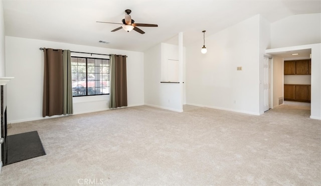 unfurnished living room with vaulted ceiling, ceiling fan, and light colored carpet