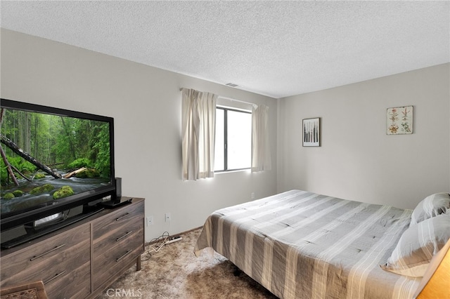 carpeted bedroom featuring a textured ceiling