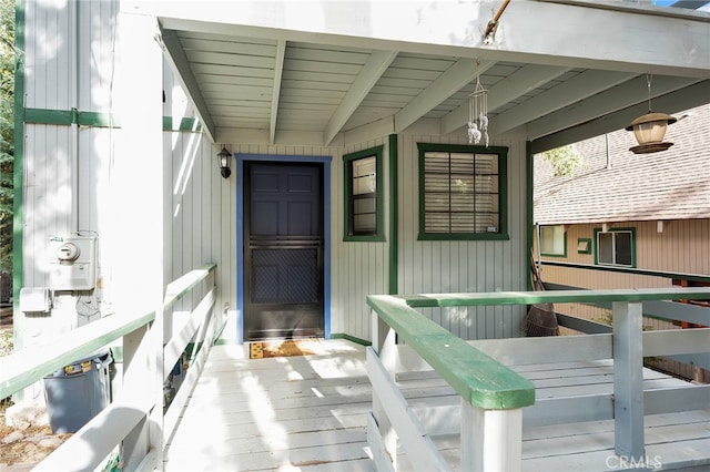 view of exterior entry with a wooden deck