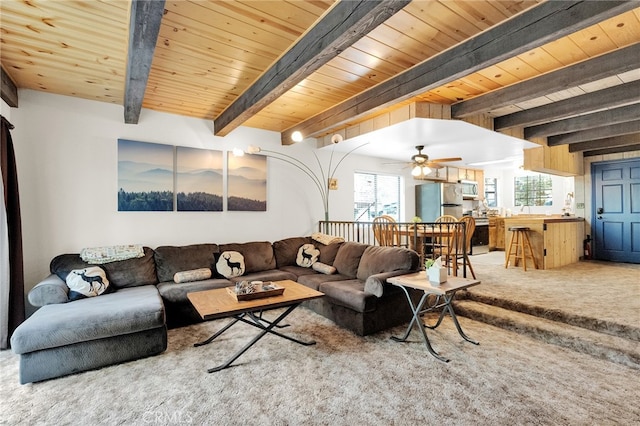 living room featuring ceiling fan, wood ceiling, beam ceiling, and carpet