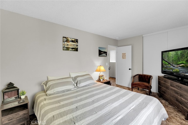 carpeted bedroom with a textured ceiling