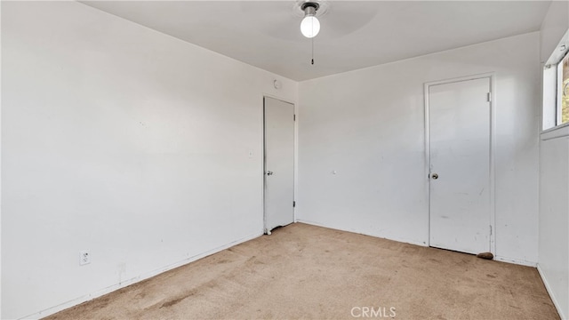 unfurnished room featuring ceiling fan and light colored carpet