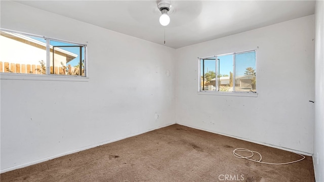 carpeted spare room featuring a wealth of natural light