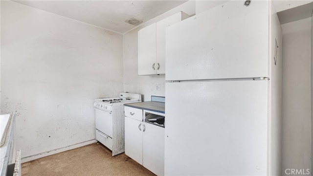 kitchen with white cabinets, white appliances, and light colored carpet