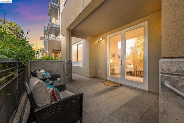 patio terrace at dusk featuring an outdoor hangout area