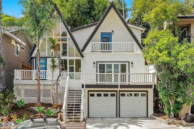 rear view of house with a balcony and a garage