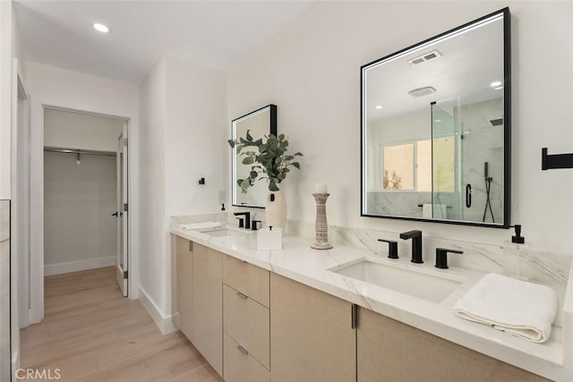 bathroom with vanity, wood-type flooring, and walk in shower