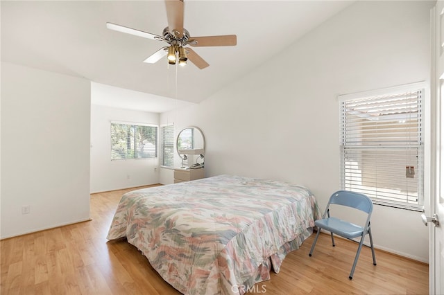 bedroom featuring ceiling fan, lofted ceiling, and light hardwood / wood-style floors