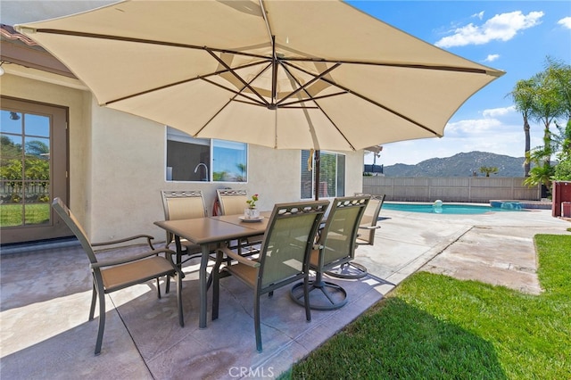 view of patio / terrace with a mountain view and a fenced in pool