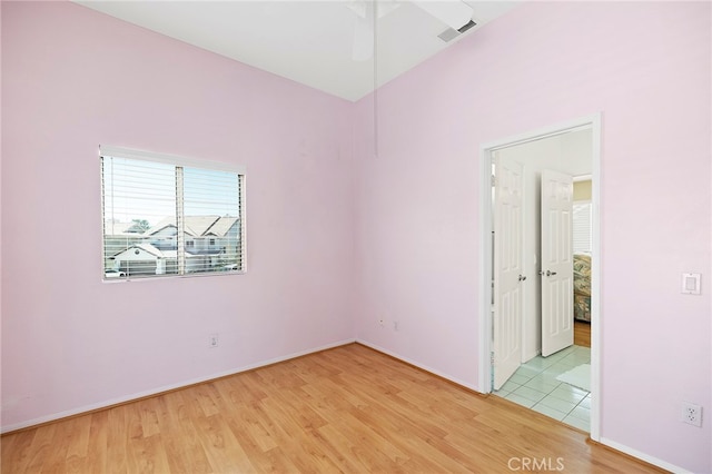 spare room featuring light wood-type flooring and ceiling fan