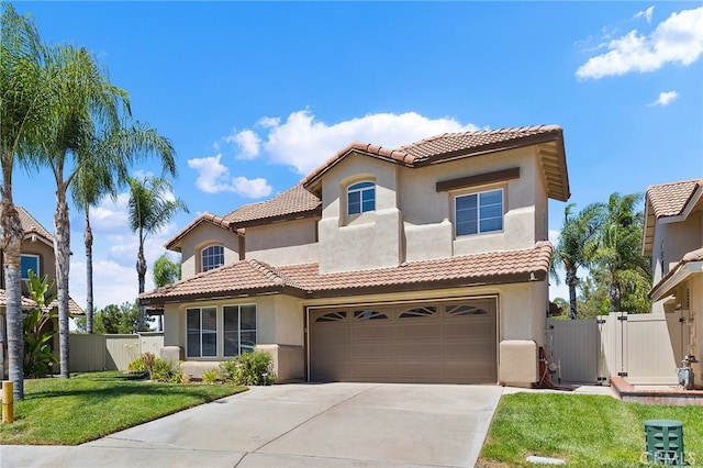 mediterranean / spanish house with a front yard and a garage