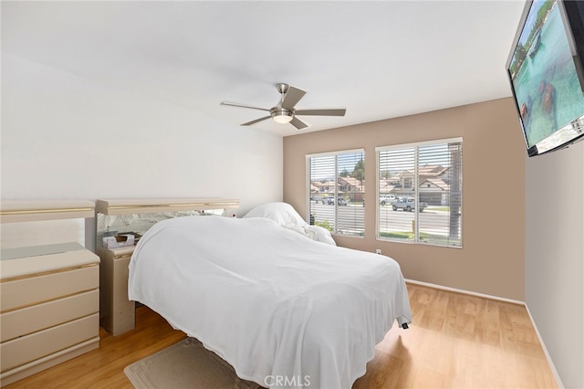 bedroom with ceiling fan and light hardwood / wood-style floors