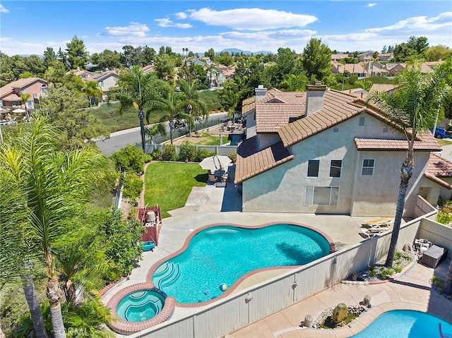 view of pool featuring a fenced in pool, a residential view, a fenced backyard, and a patio area