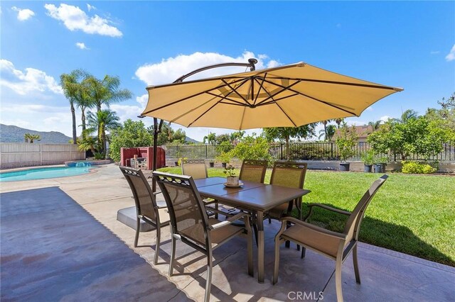 view of patio / terrace featuring a fenced in pool and a mountain view