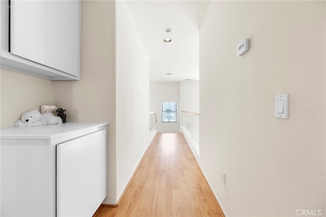 corridor with light hardwood / wood-style flooring