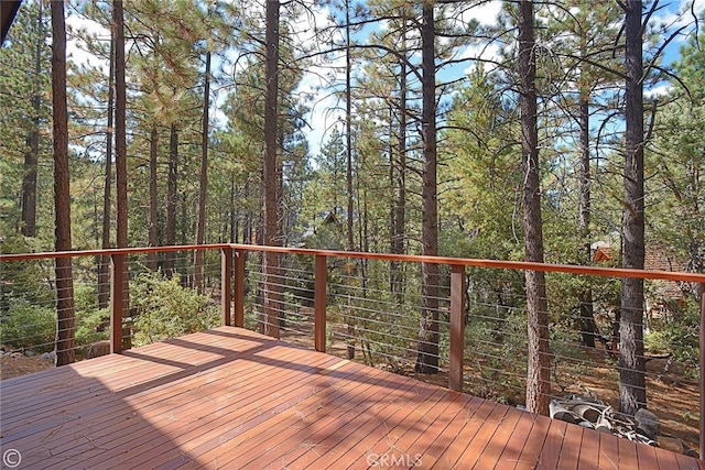 wooden terrace with a wooded view