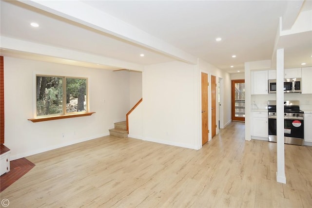 unfurnished living room featuring light wood-style flooring, recessed lighting, baseboards, stairs, and beam ceiling