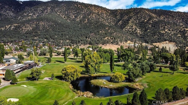 view of mountain feature featuring view of golf course and a water view