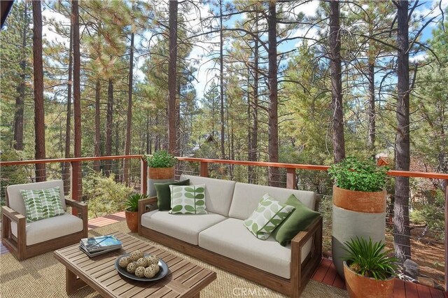 wooden terrace featuring an outdoor hangout area