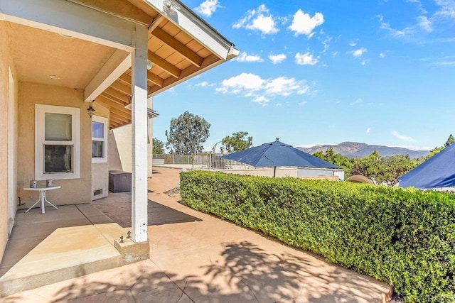 view of patio / terrace featuring a mountain view